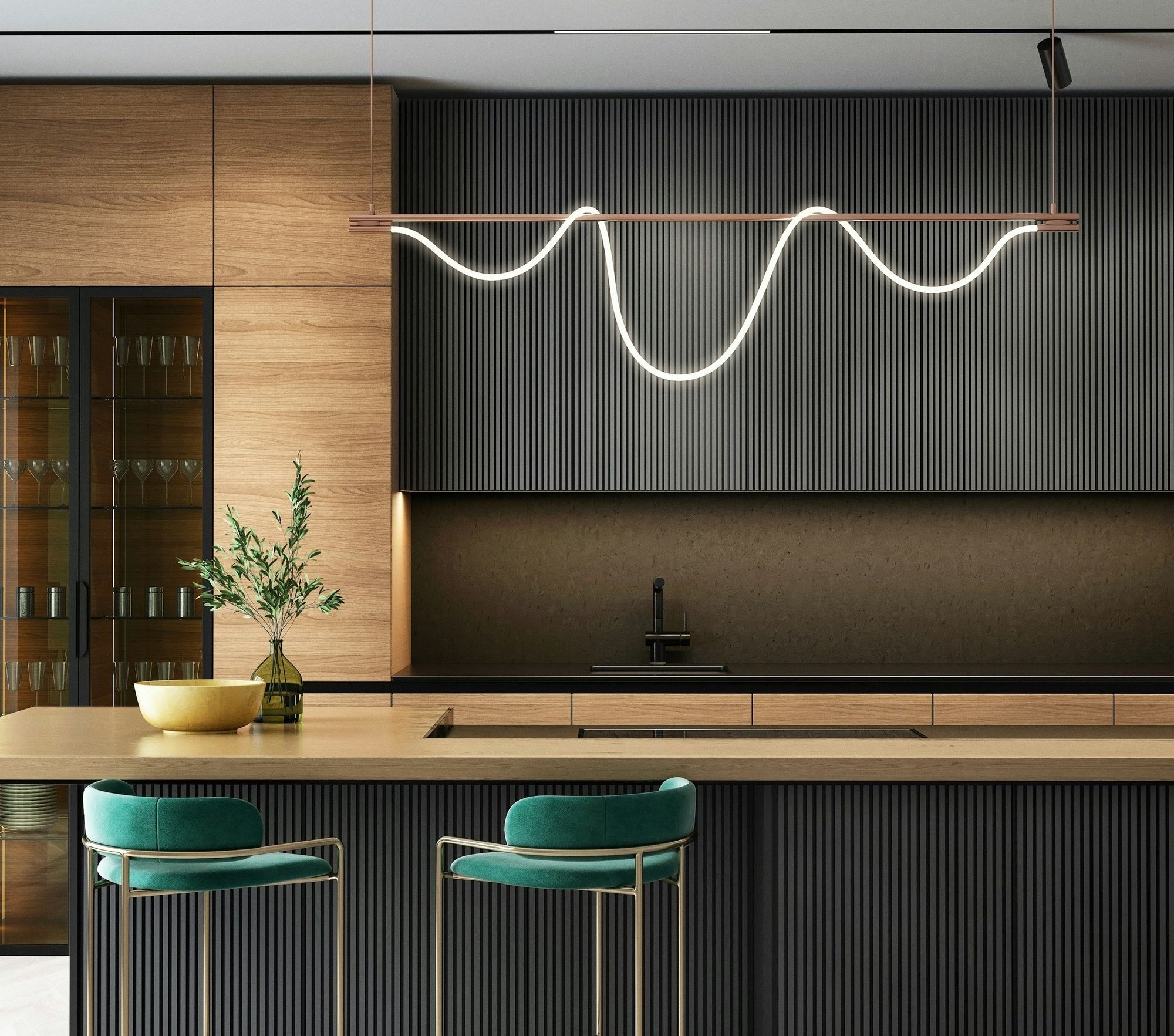 A dark fluted island under walnut cabinetry with a sculptural pendant